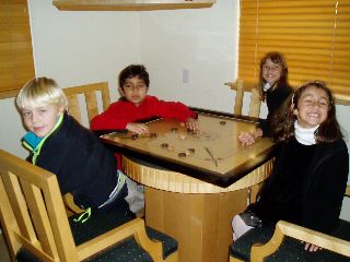 The young crowd playing carrom